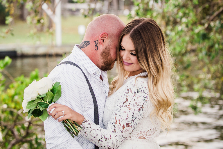 Melbourne Florida wedding at golf club bride laughing in arms of groom photo by Liz Cowie Photography
