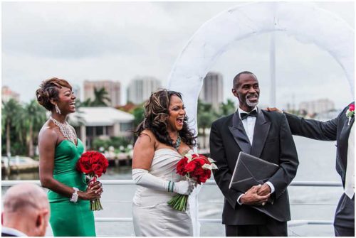 Windy wedding ceremony on top deck of yacht