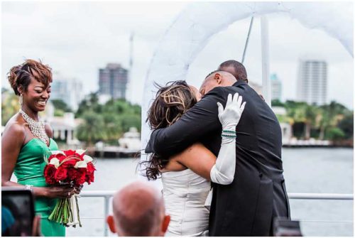 First kiss wedding ceremony on top deck of yacht
