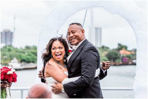 Windy wedding ceremony on top deck of yacht