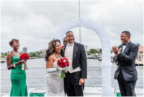 Windy wedding ceremony on top deck of yacht