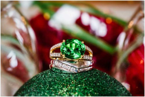 Emerald engagement ring on christmas ornament