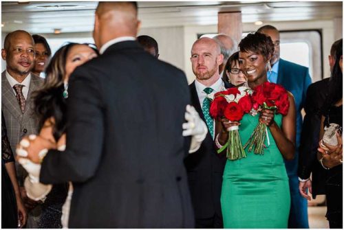 Brides daughter in green dress watching