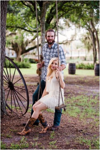 Couple on swing at Up the Creek Farms engagement