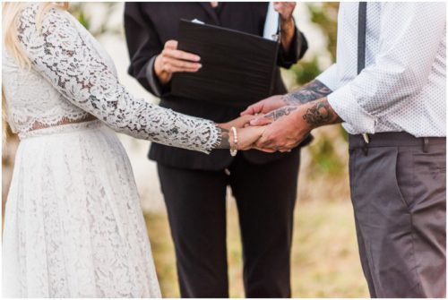 Holding hands at Chart House waterfront Wedding
