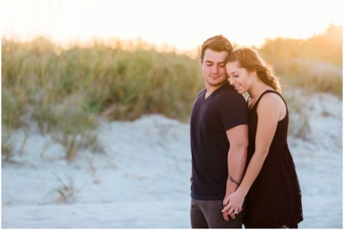 Couple hugging at Jetty Park Engagement
