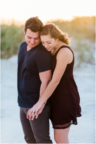 Couple hugging at Jetty Park Engagement