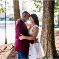 couple kissing in sun at Lake Eola engagement