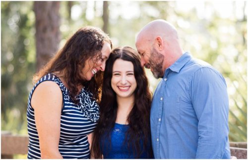 Melbourne, Florida family photography with mom and dad hugging daughter photo by Liz Cowie Photography