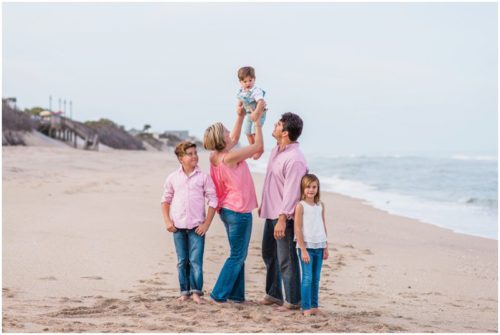 Melbourne Beach Family Photography family in pink holding up little kid photo by Liz Cowie Photography