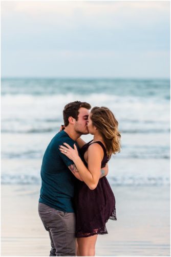 Couple kissing by ocean at Jetty Park Engagement