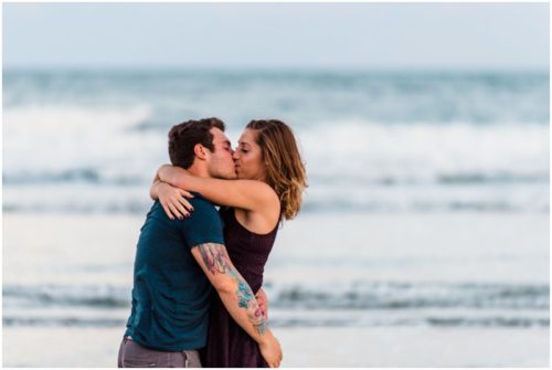 Couple kissing by ocean at Jetty Park Engagement