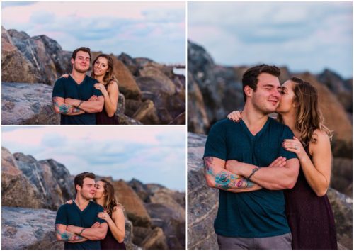 Couple hugging by rocks at Jetty Park Engagement
