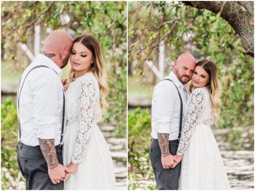 Bride and groom huggin by tree at waterfront wedding at Chart House