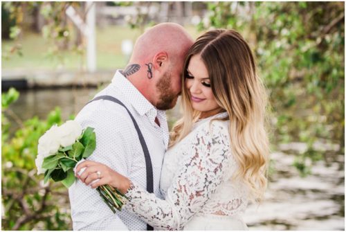 Bride and groom with bouquet at waterfront wedding at Chart House