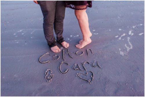 Names written in sand at Jetty Park Engagement