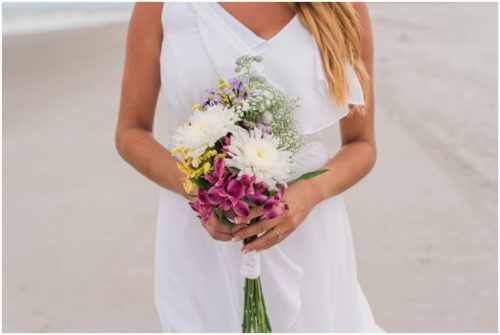 Close up of flowers and ring at beach elopement at Windemere by the Sea