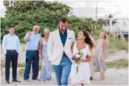 Bride and groom walking at beach elopement at Windemere by the Sea