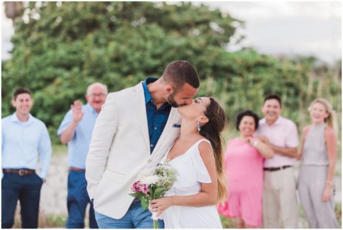 Bride and groom kissing at beach elopement at Windemere by the Sea