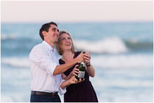 couple popping champagne on beach at Melbourne Beach Proposal
