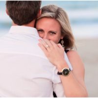 Bride looking over shoulder at beach during Melbourne Beach Proposal