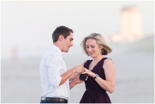 Putting ring on bride's finger during Melbourne Beach Proposal