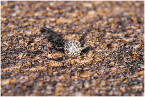 Diamond ring on sand kissing on beach at Vero Beach Engagement