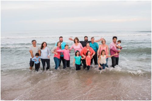 wave crashing on family at Melbourne Beach family portrait session