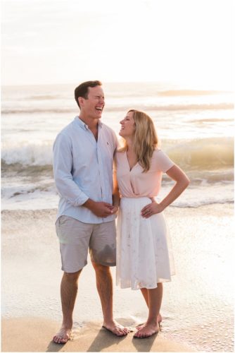 couple laughing on beach couple walking down the beach during sunrise engagement on Melbourne Beach