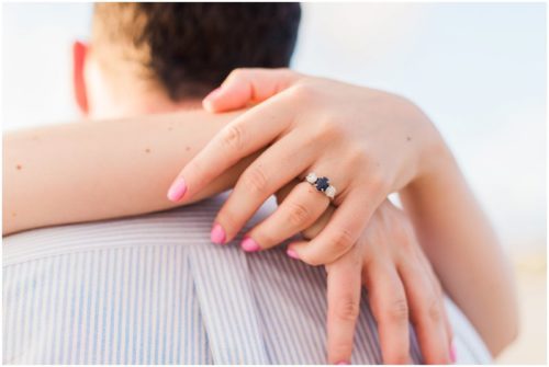 ring shot couple walking down the beach during sunrise engagement on Melbourne Beach