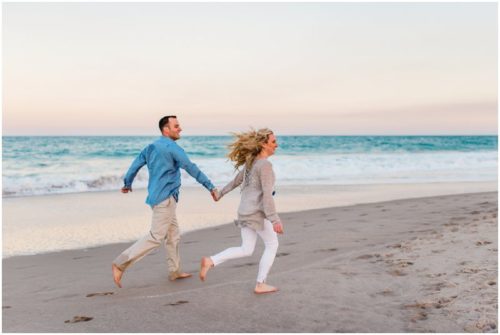 couple running down beach at Vero Beach Engagement