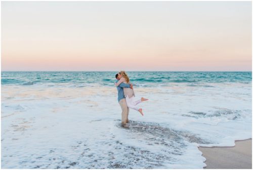 Couple twirling in ocean at Vero Beach Engagement