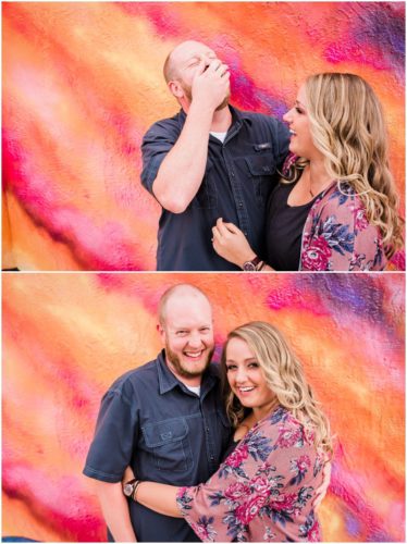 Couple laughing in front of pink wall t Melbourne engagement photography session