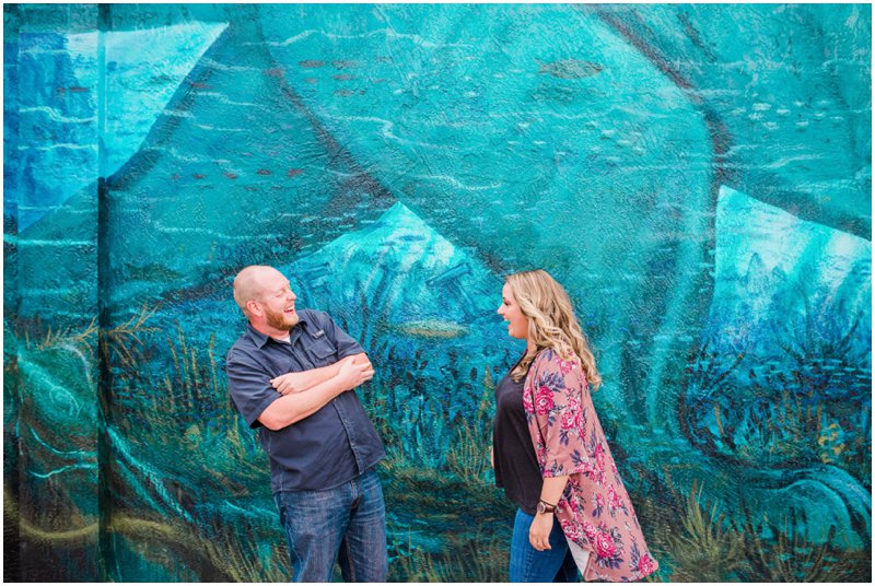 Couple having fun at downtown Melbourne, Florida engagement photography session