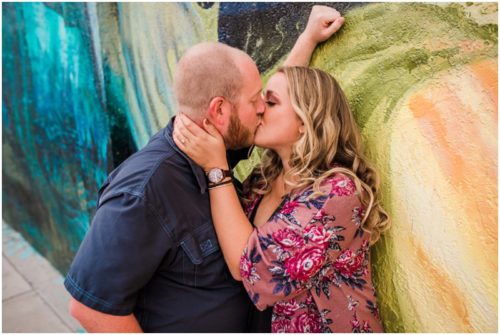 Couple kissing with yellow wall at downtown Melbourne engagement photography session