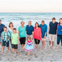 family walking with ocean in background during Melbourne Beach Family Photography session
