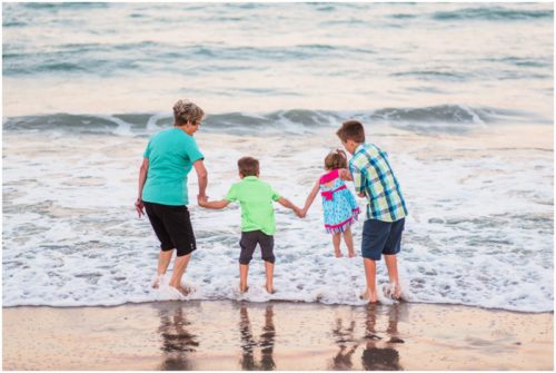 grandma playing with grandkids by ocean during Melbourne Beach Family Photography session