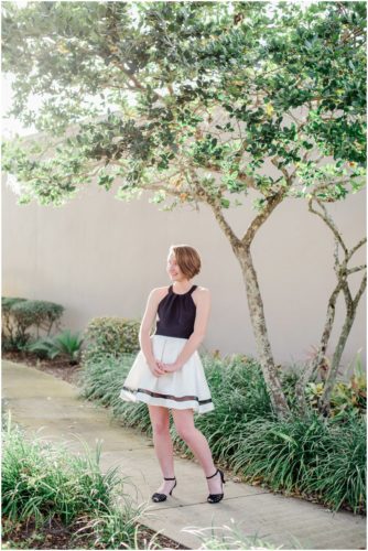 Girl standing on sidewalk during Sweet 16 portraits in downtown Eau Gallie