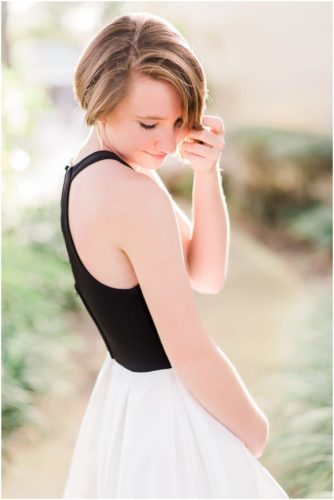 Girl standing on sidewalk during Sweet 16 portraits in downtown Eau Gallie