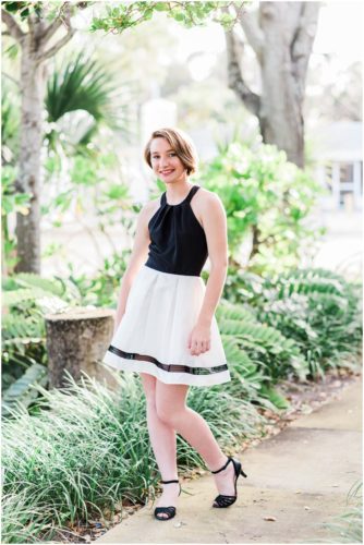 Girl standing on sidewalk during Sweet 16 portraits in downtown Eau Gallie