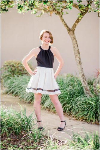 Girl standing on sidewalk during Sweet 16 portraits in downtown Eau Gallie