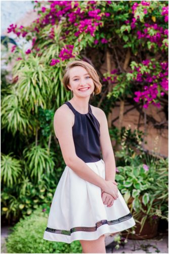 Portrait of girl with pink bushes during Sweet 16 portraits in downtown Eau Gallie