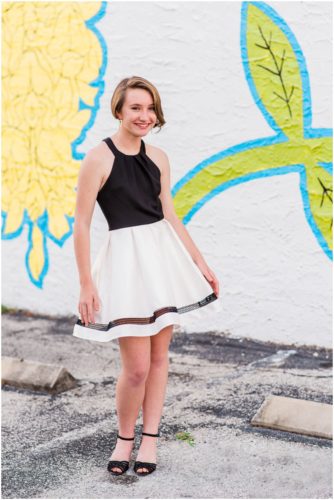 Girl behind mural during Sweet 16 portraits in downtown Eau Gallie