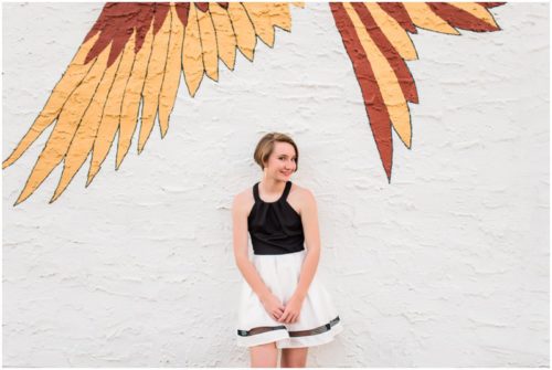 Girl under bird mural during Sweet 16 portraits in downtown Eau Gallie