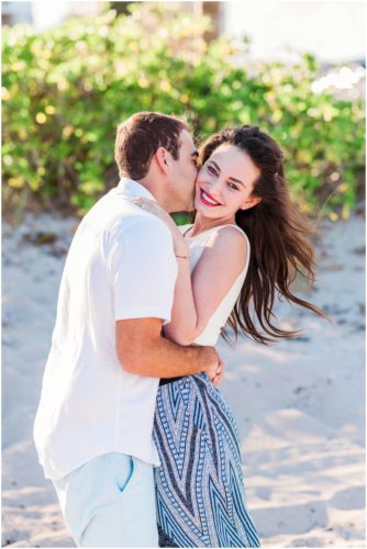 couple kissing on neck during south Florida engagement