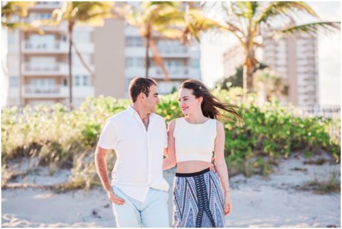 walking down beach during south Florida engagement