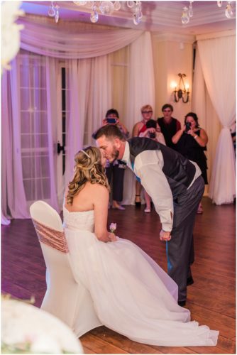 Groom taking garter Bride and groom walking on dock at Crystal Ballroom Wedding