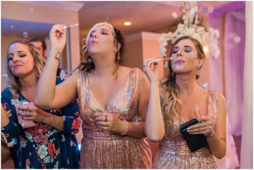 Girls blowing bubbles during Crystal Ballroom wedding
