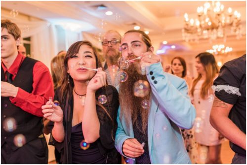 Blowing bubbles during Crystal Ballroom wedding