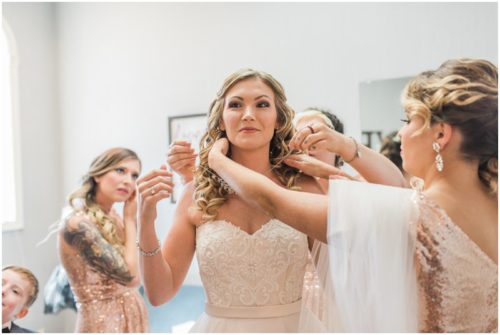 Bride getting necklace on at Crystal Ballroom Wedding